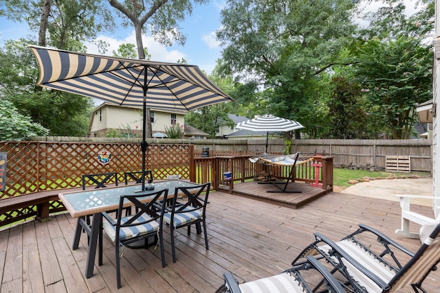 96 N Acacia Park Cir, The Woodlands, TX 77382 - wooden deck with outdoor dining area and a fenced backyard
