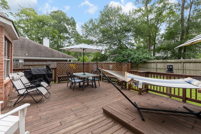 96 N Acacia Park Cir, The Woodlands, TX 77382 - wooden terrace with a grill, outdoor dining area, and a fenced backyard