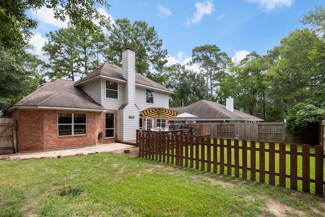 96 N Acacia Park Cir, The Woodlands, TX 77382 - back of house featuring a fenced backyard, brick siding, a chimney, a patio, and roof with shingles