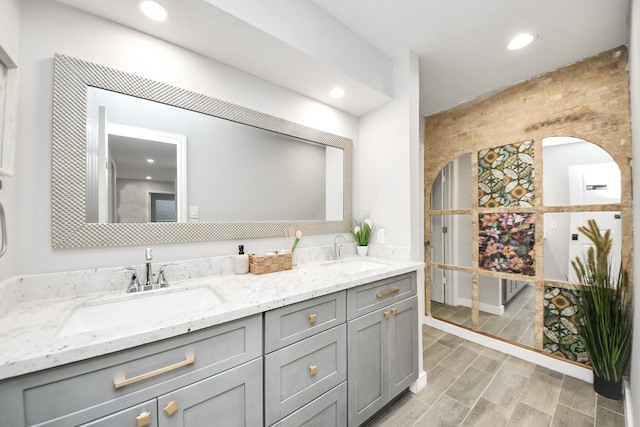 6803 Las Brisas Dr, Houston, TX 77083 - bathroom with double vanity, recessed lighting, and wood finished floors