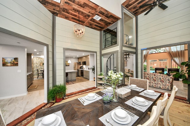 6803 Las Brisas Dr, Houston, TX 77083 - dining area featuring a towering ceiling, wood walls, wooden ceiling, light wood-style flooring, and a ceiling fan