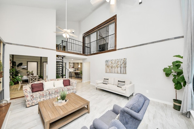 6803 Las Brisas Dr, Houston, TX 77083 - living area featuring ceiling fan, stairs, and a towering ceiling