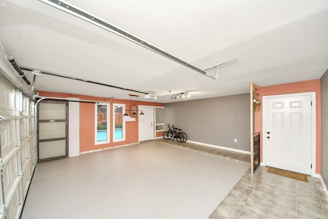 6803 Las Brisas Dr, Houston, TX 77083 - garage featuring a garage door opener and baseboards