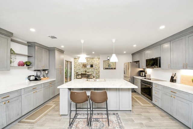 6803 Las Brisas Dr, Houston, TX 77083 - kitchen with gray cabinetry, appliances with stainless steel finishes, open shelves, an island with sink, and recessed lighting