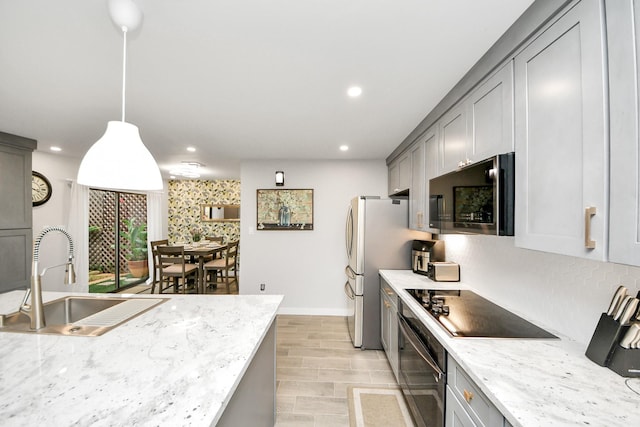 6803 Las Brisas Dr, Houston, TX 77083 - kitchen featuring appliances with stainless steel finishes, gray cabinets, light wood finished floors, recessed lighting, and backsplash