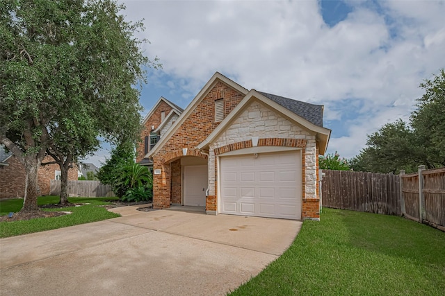 21002 Beech Landing Ln, Katy, TX 77450 - view of front of home with driveway, stone siding, an attached garage, and brick siding