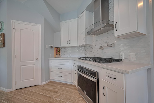 21002 Beech Landing Ln, Katy, TX 77450 - kitchen with stainless steel appliances, wall chimney range hood, white cabinets, and backsplash
