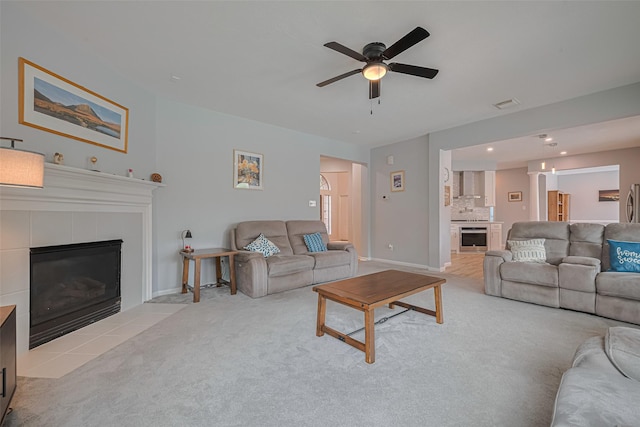 21002 Beech Landing Ln, Katy, TX 77450 - living room featuring ceiling fan, a tile fireplace, wine cooler, carpet, and recessed lighting