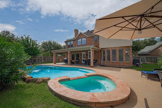 21002 Beech Landing Ln, Katy, TX 77450 - view of swimming pool featuring a patio area, a fenced backyard, and a pool with connected hot tub