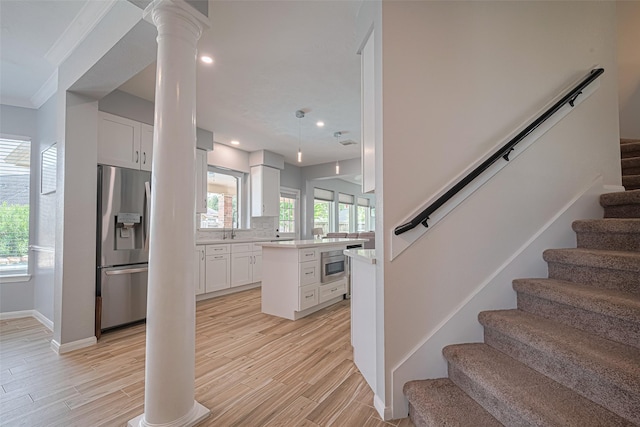 21002 Beech Landing Ln, Katy, TX 77450 - stairway featuring decorative columns, wood finished floors, recessed lighting, and ornamental molding