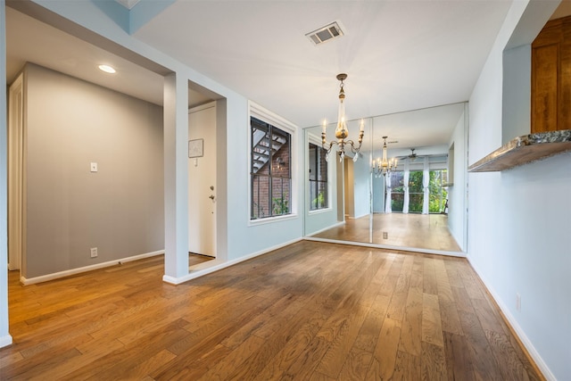 2829 Timmons Ln Unit 101, Houston, TX 77027 - unfurnished dining area featuring a chandelier, wood-type flooring, and recessed lighting