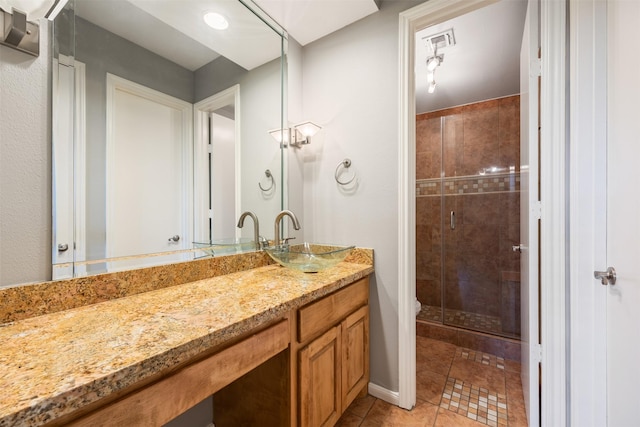 2829 Timmons Ln Unit 101, Houston, TX 77027 - bathroom featuring vanity, a stall shower, and tile patterned floors