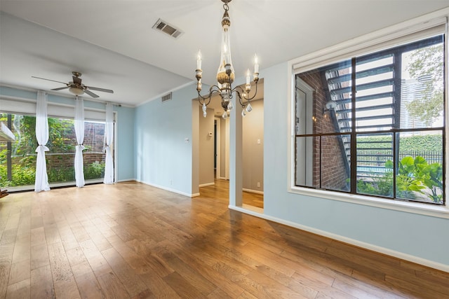 2829 Timmons Ln Unit 101, Houston, TX 77027 - empty room with a chandelier, plenty of natural light, hardwood / wood-style flooring, and crown molding