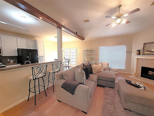 4134 Teal Valley Ct, Fresno, TX 77545 - living room with light wood-style flooring, a ceiling fan, and a tiled fireplace