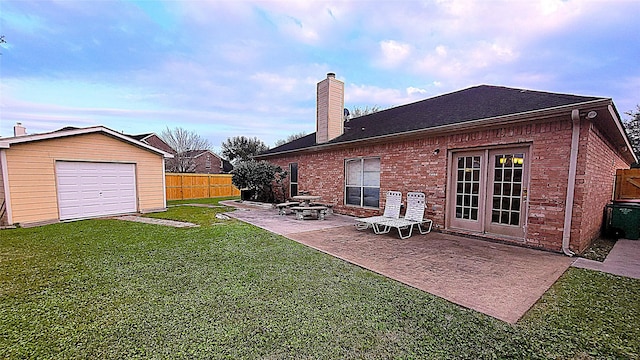 4134 Teal Valley Ct, Fresno, TX 77545 - back of house featuring a chimney, a patio area, brick siding, an outbuilding, and a garage