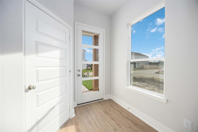 13208 Opera Dr, Houston, TX 77047 - doorway featuring light wood-style flooring and healthy amount of natural light