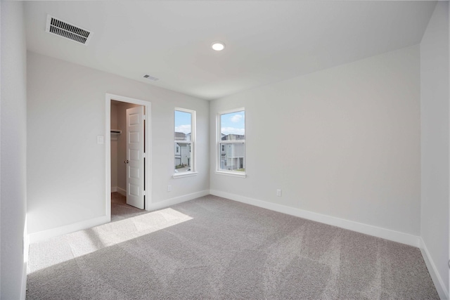13208 Opera Dr, Houston, TX 77047 - unfurnished bedroom with light colored carpet, a walk in closet, and recessed lighting