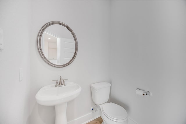 13208 Opera Dr, Houston, TX 77047 - bathroom featuring baseboards and toilet