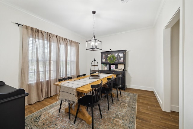 2201 Maple St, Liberty, TX 77575 - dining room with a chandelier, crown molding, and dark wood-type flooring