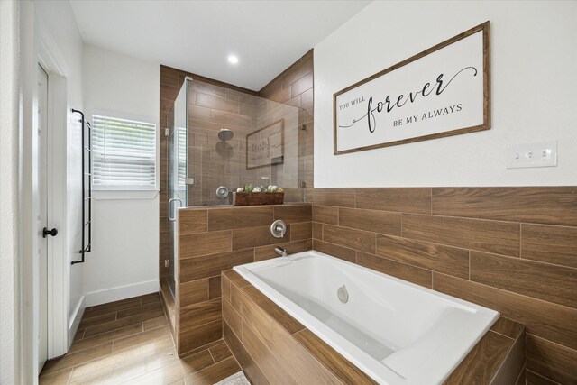 2201 Maple St, Liberty, TX 77575 - full bath with a shower stall, a bath, wood finished floors, and recessed lighting