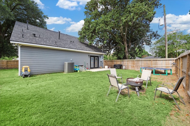 2201 Maple St, Liberty, TX 77575 - back of house featuring an outdoor fire pit, a fenced backyard, and roof with shingles