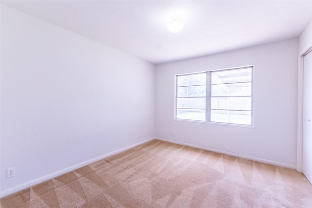 7734 El Rancho St, Houston, TX 77087 - empty room featuring light carpet and baseboards