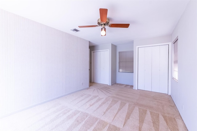 7734 El Rancho St, Houston, TX 77087 - unfurnished bedroom featuring two closets, carpet floors, and ceiling fan
