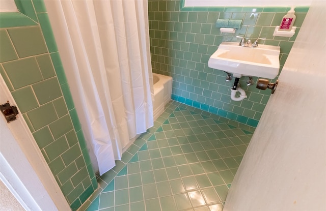 7734 El Rancho St, Houston, TX 77087 - bathroom with tile patterned flooring, tile walls, and shower / bath combo