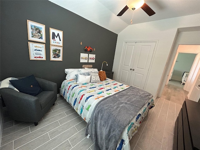20130 New Sunrise Trl, Cypress, TX 77433 - bedroom with wood finish floors, vaulted ceiling, a closet, and a ceiling fan