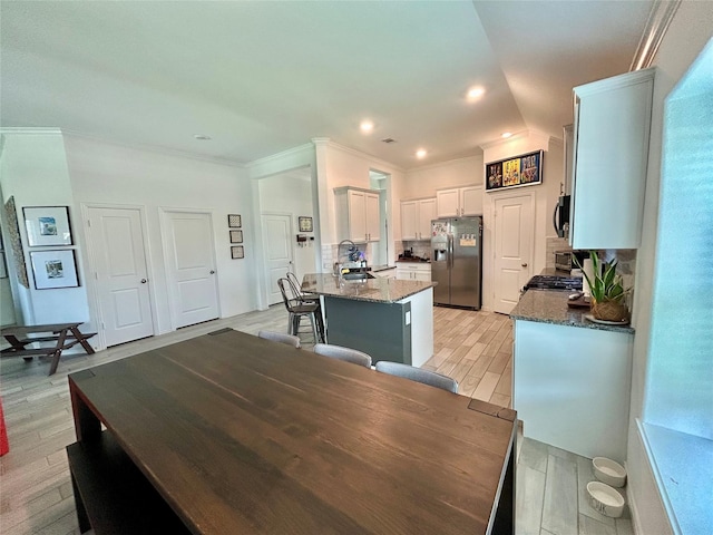 20130 New Sunrise Trl, Cypress, TX 77433 - dining area featuring ornamental molding and light wood-type flooring