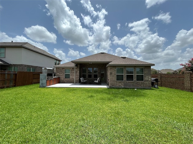 20130 New Sunrise Trl, Cypress, TX 77433 - back of property with a patio, a fenced backyard, brick siding, and a shingled roof