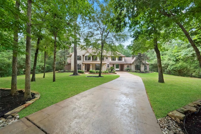 10332 Hunter Creek Ln, Conroe, TX 77304 - view of front of property featuring driveway, a front yard, and stone siding