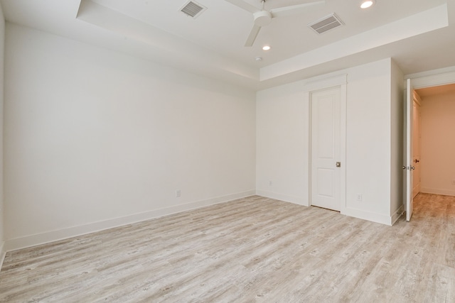 2717 Oakwood Crest Ln, Houston, TX 77018 - unfurnished bedroom with a tray ceiling, light wood-style flooring, recessed lighting, and ceiling fan