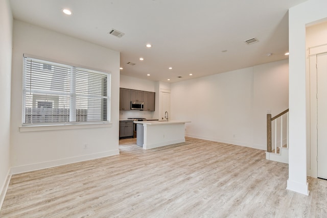 2717 Oakwood Crest Ln, Houston, TX 77018 - unfurnished living room featuring light wood-type flooring, recessed lighting, and stairway