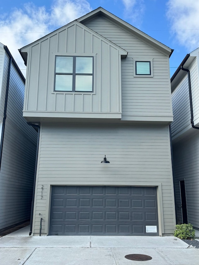 2717 Oakwood Crest Ln, Houston, TX 77018 - view of front facade with a garage, board and batten siding, and driveway