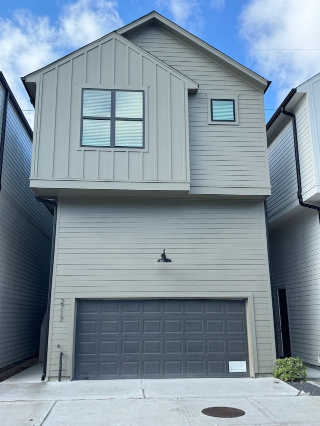 2717 Oakwood Crest Ln, Houston, TX 77018 - view of front of home with an attached garage, board and batten siding, and driveway