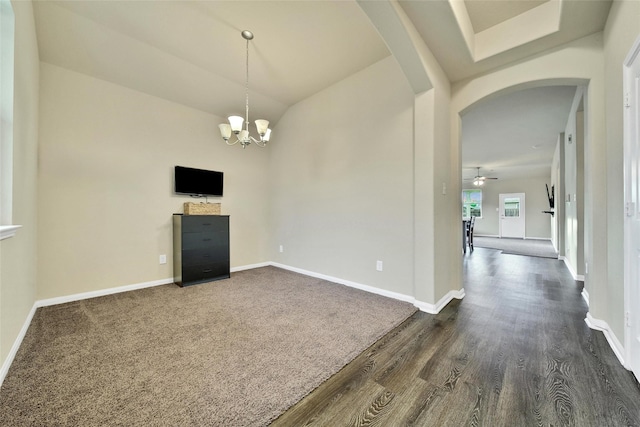 7427 Wheatley Gardens Dr, Houston, TX 77016 - spare room featuring arched walkways, dark wood-type flooring, a chandelier, and lofted ceiling
