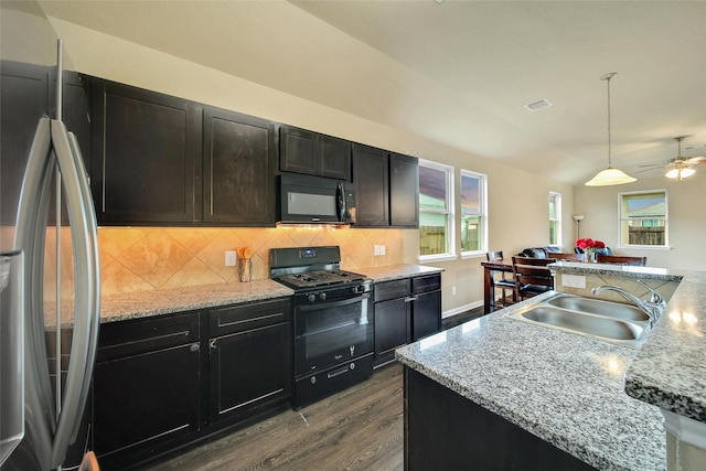 7427 Wheatley Gardens Dr, Houston, TX 77016 - kitchen featuring black appliances, dark wood finished floors, decorative backsplash, and a ceiling fan