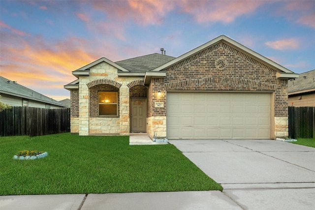 7427 Wheatley Gardens Dr, Houston, TX 77016 - french country inspired facade featuring an attached garage, driveway, stone siding, brick siding, and roof with shingles