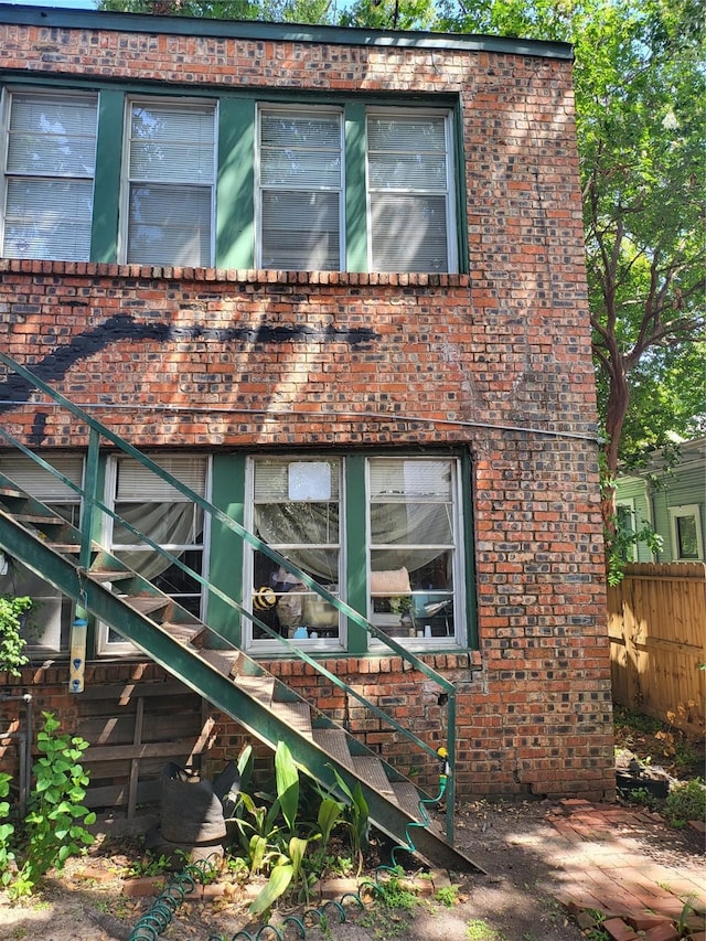 1529 Welch St, Houston, TX 77006 - view of side of home featuring brick siding and stairway