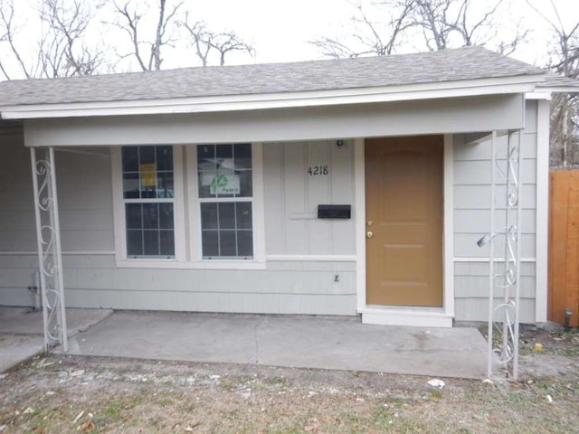 4218 Buck St, Houston, TX 77020 - view of exterior entry featuring a shingled roof