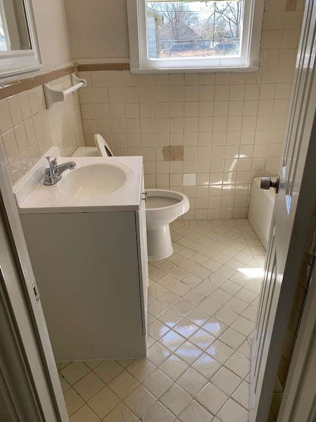 4218 Buck St, Houston, TX 77020 - half bath featuring vanity, tile walls, and tile patterned flooring