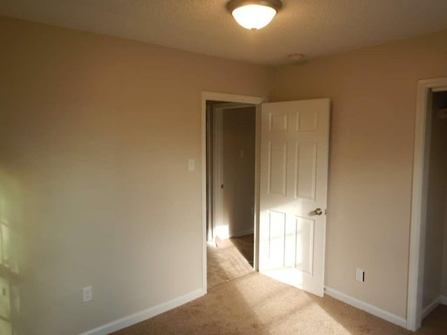 4218 Buck St, Houston, TX 77020 - unfurnished bedroom featuring light colored carpet and a textured ceiling