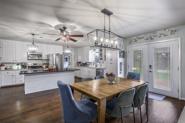 502 Spinn St, Brenham, TX 77833 - dining space with a chandelier, ceiling fan, and dark wood-style floors