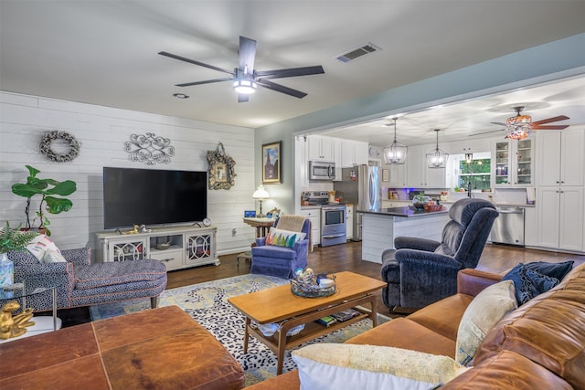 502 Spinn St, Brenham, TX 77833 - living area featuring a ceiling fan and dark wood-style flooring