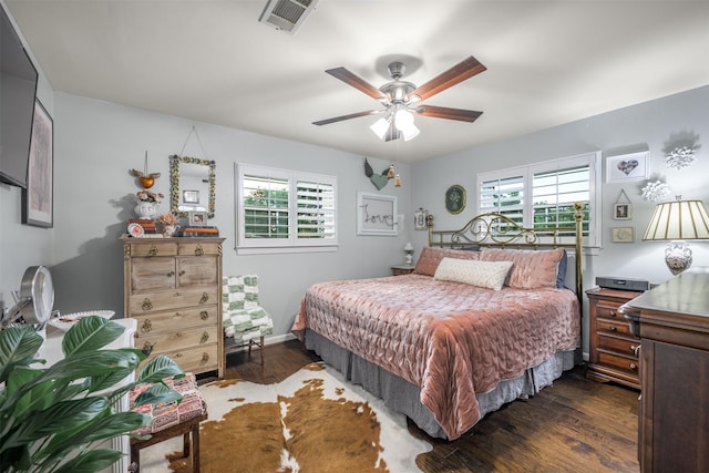 502 Spinn St, Brenham, TX 77833 - bedroom with multiple windows, dark wood-style floors, and ceiling fan