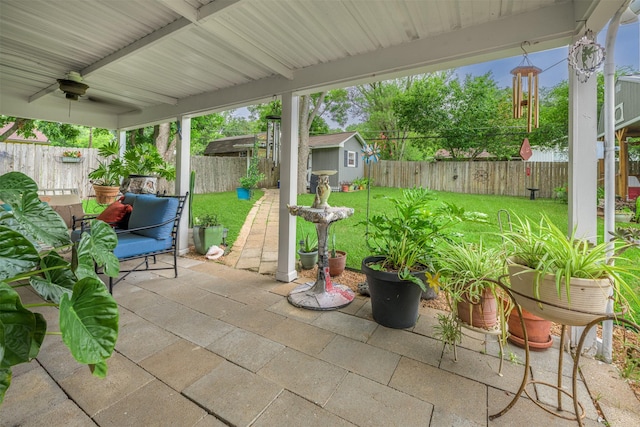 502 Spinn St, Brenham, TX 77833 - fenced backyard with a patio area, a ceiling fan, and a shed
