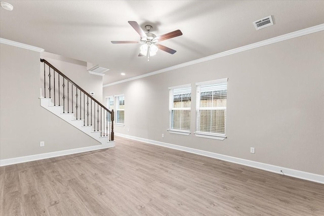 7970 Fowlie St, Houston, TX 77028 - unfurnished living room featuring crown molding, wood finished floors, ceiling fan, and stairway