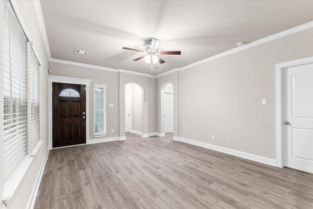 7970 Fowlie St, Houston, TX 77028 - foyer with wood finished floors, ceiling fan, arched walkways, and crown molding