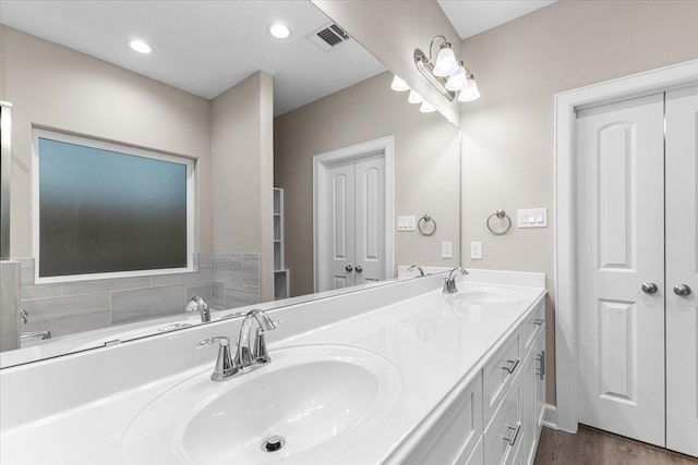 7970 Fowlie St, Houston, TX 77028 - bathroom featuring double vanity, wood finished floors, recessed lighting, and a tub